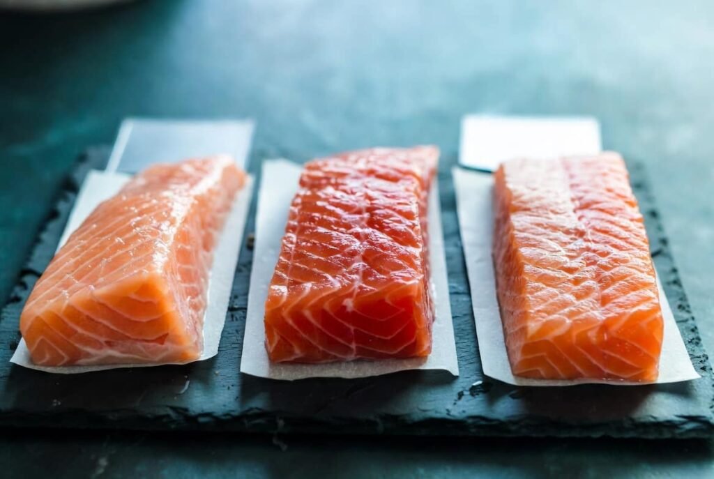 Comparison of Atlantic Sockeye and Pink salmon fillets showing color and texture differences